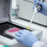 Tecnico di laboratorio con guanti che carica con una pipetta multicolore campioni biologici in una piastra per Real-Time PCR, primo piano sulle mani e sulla piastra, sfondo sfocato di un moderno laboratorio high-tech con strumentazione avanzata, obiettivo macro 85mm, illuminazione precisa e controllata.