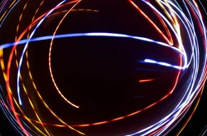 Visualizzazione astratta di percorsi di apprendimento individualizzati che convergono verso un obiettivo, rappresentati da linee luminose su sfondo scuro. Simboleggia la personalizzazione e la precisione del metodo MIEBL nel DTT. Wide-angle lens, 15mm, long exposure, sharp focus.