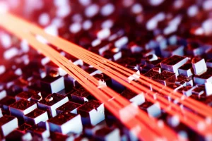 Visualizzazione artistica fotorealistica di nanocristalli di WO3-x che assorbono luce nel vicino infrarosso (rappresentata come fasci rossastri convergenti). I nanocristalli hanno un aspetto quasi metallico e mostrano l'effetto LSPR come un bagliore superficiale. Scena catturata con un obiettivo prime da 35mm, profondità di campo ridotta per focalizzare sui nanocristalli, illuminazione drammatica per evidenziare l'assorbimento NIR.