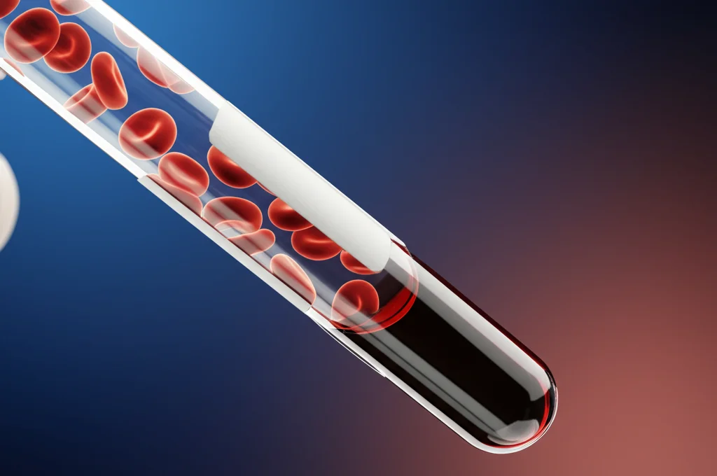 Primo piano di una provetta di sangue in un laboratorio di analisi mediche, messa a fuoco precisa sui globuli rossi visibili, illuminazione controllata da laboratorio, obiettivo macro 100mm, alta definizione dei dettagli cellulari.
