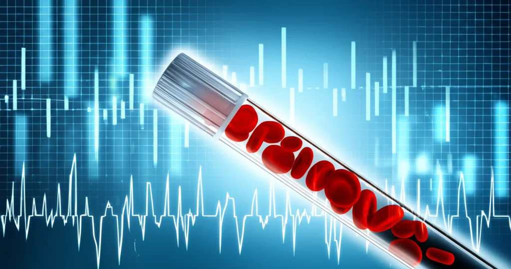 Primo piano di una provetta di sangue con globuli rossi visibili, accanto a un grafico digitale astratto che mostra fluttuazioni di dati medici. Illuminazione controllata, lente macro 90mm, alta definizione per evidenziare i dettagli del sangue e la nitidezza del grafico.