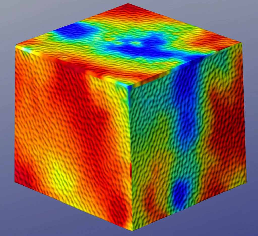 Visualizzazione 3D scientifica di un cubo metallico (15mm, Invar-TiCN) con mappatura a colori dello stress residuo, zone blu intenso (compressione) all'interno, zone rosse/arancio (tensione) sulle superfici, rendering fotorealistico ad alta definizione, illuminazione da studio.