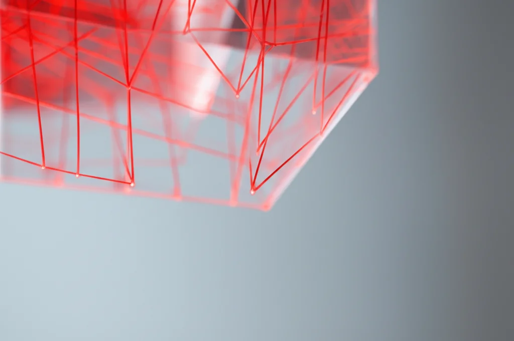 Rappresentazione fotorealistica di un dominio 3D traslucido (come vetro o acrilico) contenente una rete sparsa di sottili linee rette luminose rosse che collegano punti sul bordo, obiettivo grandangolare, 20mm, messa a fuoco nitida, profondità di campo, sfondo minimalista.
