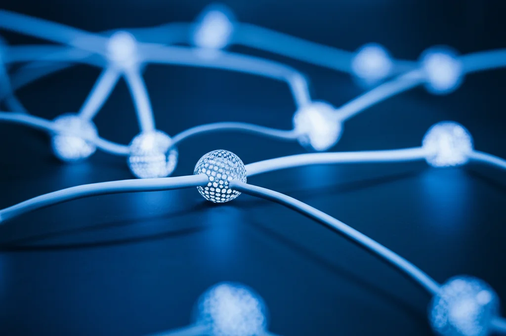 Immagine fotorealistica di nodi di rete interconnessi (dispositivi IoT stilizzati) con alcuni collegamenti più spessi di altri, a simboleggiare pesi diversi. Macro lens, 60mm, high detail, luce controllata, sfondo leggermente sfocato per profondità di campo.