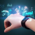 A hand wearing a sleek wearable device, with abstract data visualizations flowing around it, representing health monitoring and research. 35mm portrait, depth of field, controlled lighting.