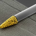 Macro lens, 80mm, high detail, precise focusing, controlled lighting of a glassy carbon electrode tip coated with a rough, porous layer of gold nanoparticles and iron metal-organic frameworks, symbolizing the core technology.