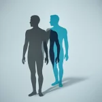 Immagine concettuale che rappresenta lo stigma: una figura umana stilizzata con un'ombra proiettata più grande e distorta, con colori duotone blu e grigio, per simboleggiare il peso invisibile dello stigma nella fibrosi cistica. Lente prime 35mm, profondità di campo.