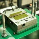 A detailed, precisely focused image of a green sand mold sample within a direct shear test apparatus, highlighting the scientific equipment used to measure mechanical properties accurately.