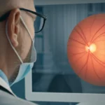 Photorealistic image of a doctor looking at a digital display showing a retinal fundus image with potential AMD lesions highlighted, 35mm portrait lens, controlled lighting.