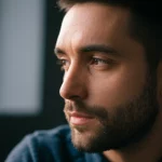 Photorealistic portrait, 35mm lens, depth of field, a thoughtful person looking into the distance, suggesting the link between mind and future health.