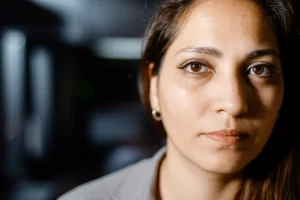 A thoughtful portrait of a person, representing introspection and narrative identity, captured with a 35mm lens, featuring depth of field to isolate the subject.