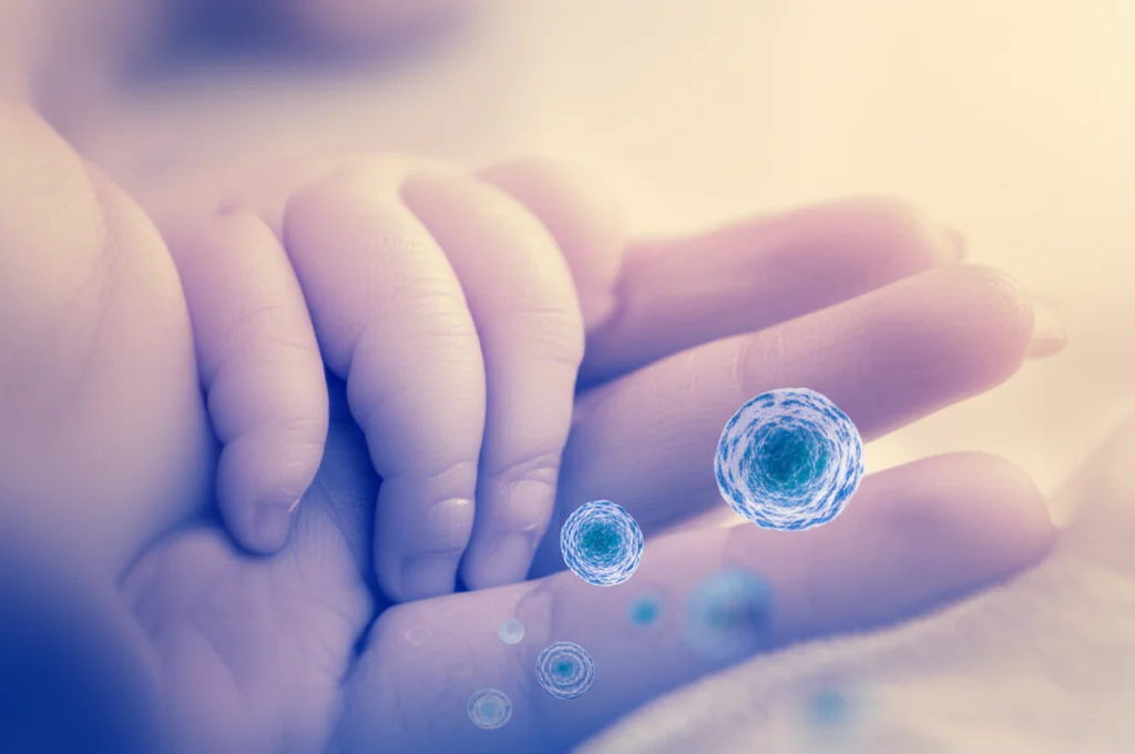 Conceptual image depicting a newborn baby's hand gently held by a mother's hand, with a subtle, almost imperceptible overlay of abstract cellular structures representing monocytes. Use a prime lens, 35mm, with soft, warm lighting and a shallow depth of field to create a tender, hopeful mood, hinting at the underlying science. Perhaps a duotone effect with warm skin tones and a cool, scientific blue for the cellular overlay.