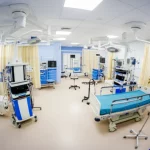 A photorealistic wide-angle shot of a state-of-the-art nursing simulation lab, empty but ready for training. Wide-angle lens, 15mm, sharp focus throughout the room, showcasing advanced mannequins and medical equipment under bright, even lighting, conveying a sense of preparedness and technological advancement in education.