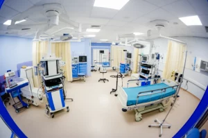 A photorealistic wide-angle shot of a state-of-the-art nursing simulation lab, empty but ready for training. Wide-angle lens, 15mm, sharp focus throughout the room, showcasing advanced mannequins and medical equipment under bright, even lighting, conveying a sense of preparedness and technological advancement in education.