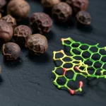 Macro fotografia di grani di pepe nero e una rappresentazione molecolare stilizzata di piperina complessata con un glucano ciclico, illuminazione controllata per dettagli precisi, obiettivo macro 100mm.