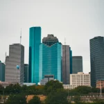 Urban Houston skyline with visible air particles, wide-angle lens, 24mm, sharp focus, showing the context of the study.