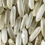 Fotografia macro di chicchi di riso di alta qualità, alcuni traslucidi e perfetti, altri con evidenti aree opache e gessose, illuminazione da studio per evidenziare la texture, obiettivo macro 100mm, alta definizione, precisa messa a fuoco sui dettagli della gessosità.