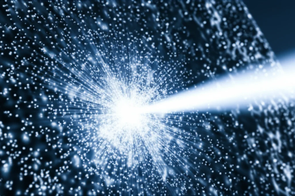 A photorealistic image depicting a brilliant X-ray beam from a synchrotron source impinging on a disordered, amorphous metallic alloy sample. Subtle, glowing speckle patterns emanate from the interaction point. Focus on the beam and the sample surface. Use a prime lens, 35mm, with depth of field, emphasizing the high-tech, scientific environment. Duotone, perhaps blue and silver.