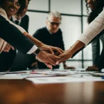 A group of diverse individuals collaborating around a table in a modern office, symbolizing human-centered decision making and growth in organizations, wide-angle lens, 24mm, sharp focus, natural lighting.