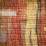 Photorealistic object photography macro lens 100mm of a detailed section of an ancient Dunhuang textile, showing intricate silk weave and faded colors, with a subtle overlay suggesting scientific analysis, high detail, precise focusing, controlled lighting.