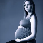 Photorealistic portrait of a pregnant woman looking thoughtful, 35mm portrait, depth of field, blue and grey duotones.