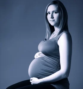 Photorealistic portrait of a pregnant woman looking thoughtful, 35mm portrait, depth of field, blue and grey duotones.