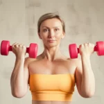 Portrait photography, 35mm portrait, depth of field, showing a confident, healthy postmenopausal woman lifting a light weight, soft lighting.