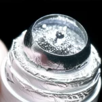 Macro lens, 60mm, precise focusing, controlled lighting, detailed view of a LaBr3(Ce) scintillation crystal wrapped in a reflective material.