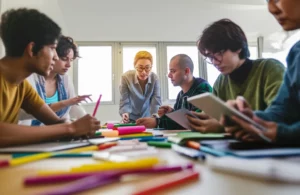 A dynamic classroom scene: a teacher with an encouraging expression observing a diverse group of university students engaged in a collaborative creative project, using colorful materials and digital tablets. Prime lens, 35mm, depth of field, vibrant and inspiring atmosphere.