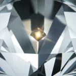 Photorealistic image of a diamond crystal containing a single, glowing nitrogen-vacancy center, viewed with a macro lens at 70mm, showing high detail and controlled lighting.