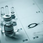 A dynamic composition, prime lens 35mm, showing a collection of emergency medication vials (naloxone, epinephrine, dopamine, dexamethasone, dobutamine) alongside a calendar with a date circled past its expiration, symbolizing the study. Depth of field, with medications in sharp focus and calendar slightly blurred. Duotone effect, perhaps blue and grey, for a serious yet hopeful feel.