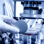 Photorealistic image of a hand carefully placing a silver disc into a laboratory leaching apparatus, symbolizing the research into eco-friendly silver extraction, 60mm macro lens, precise focusing, controlled lighting.