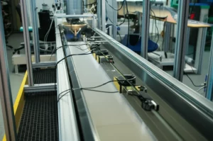 Photorealistic image of a laboratory flume setup used for viscous debris flow experiments, showing the mixing tank, channel, and sensors under controlled lighting conditions, precise focusing, macro lens, 100mm.