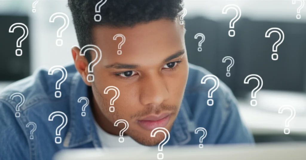A student looking critically at a document on a screen, with question marks subtly overlaid, 24mm lens, depth of field.