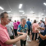 Photorealistic image of older adults engaging in a community activity in Guangzhou, China, wide-angle lens, 24mm, sharp focus.
