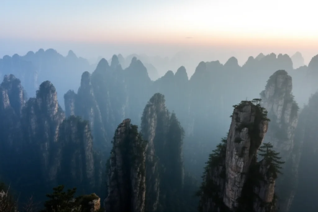 Wide-angle landscape photography, 10mm lens, sharp focus, a stunning Karst mountain range with unique peaks and mist in South China.