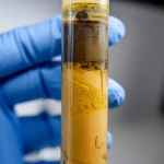 A sediment core sample being analyzed in a laboratory, macro lens, 60mm, high detail, controlled lighting.