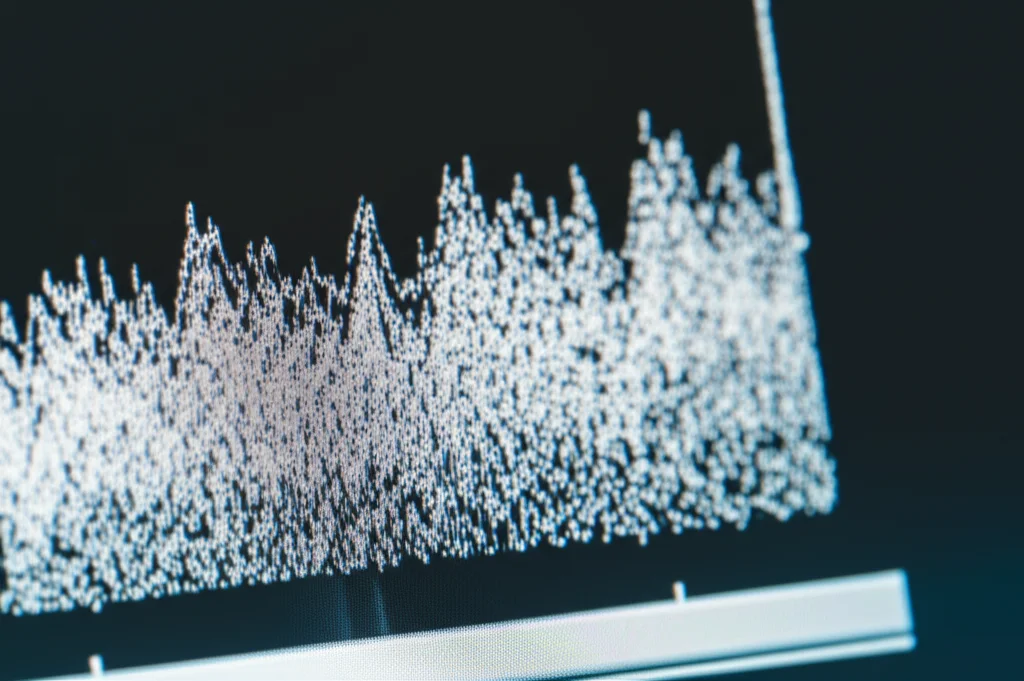 Photorealistic close-up of a digital display showing a jagged, noisy data curve transforming into a smooth, clear curve through filtering, macro lens, 90mm, high detail, controlled studio lighting.