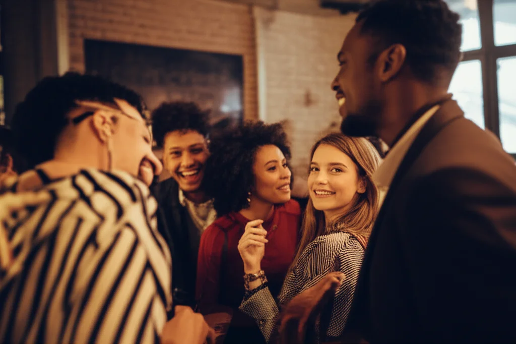 Portrait photography, 35mm, depth of field, showing a diverse group of young adults in a bar setting, some smiling, others looking hesitant, capturing the mixed emotions and social dynamics of flirtation and initial encounters.
