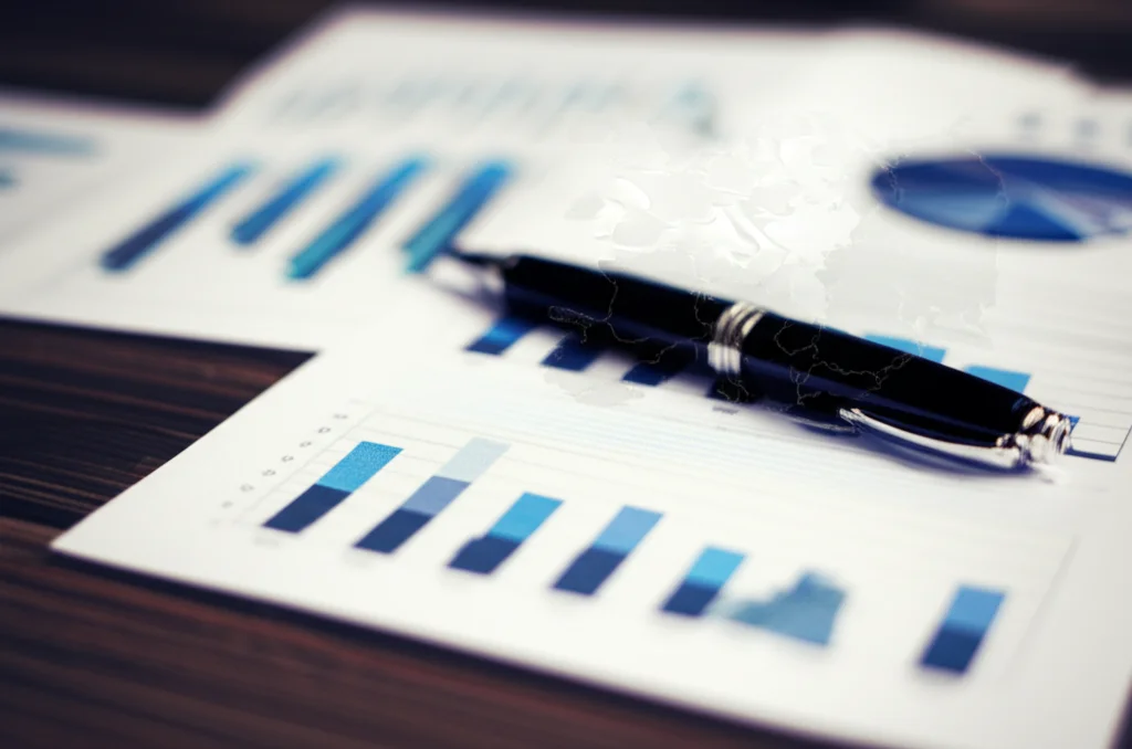 Still life of bar charts and graphs on a desk, overlaid with a subtle map of Europe, 100mm macro lens, precise focusing, high detail, illustrating data analysis of compliance with environmental law across EU member states.